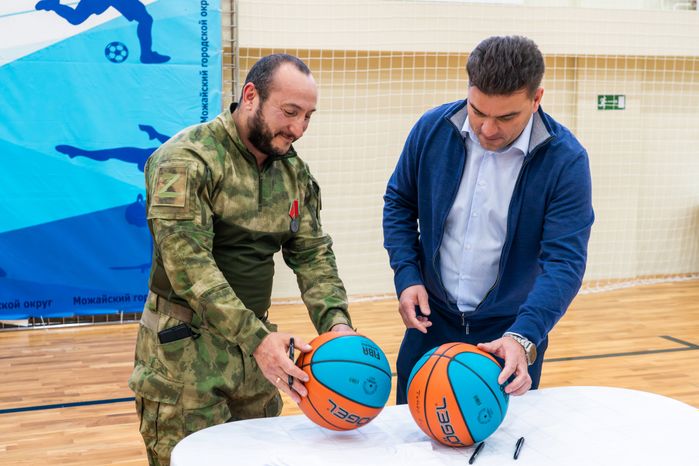 Глава Можайского округа Денис Мордвинцев и ветеран СВО Роман Гомыляев подписали мячи для удачи в Единой школьной лиге